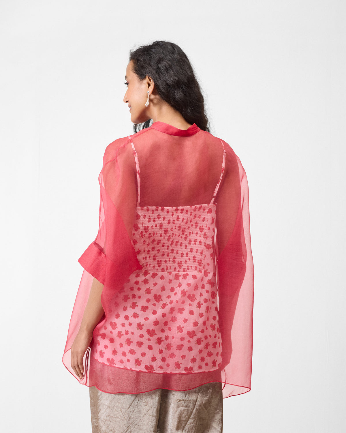 Back of a sheer watermelon shirt over a printed slip.