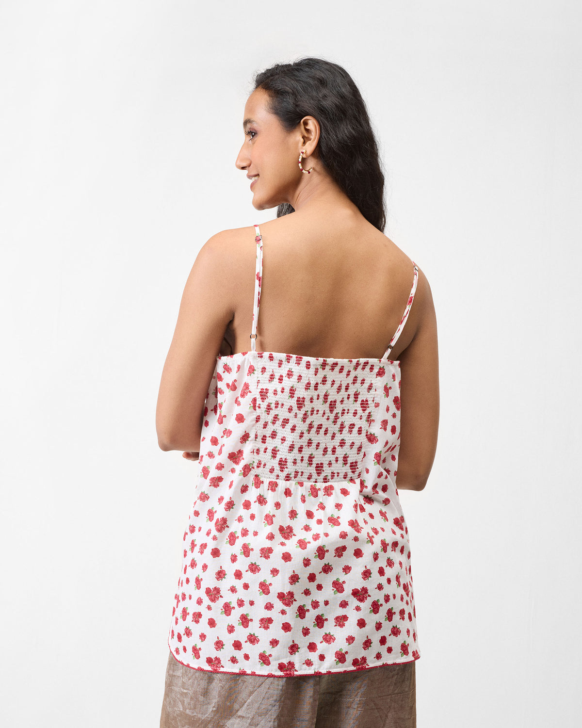 Back of a white floral slip with a smocked panel.