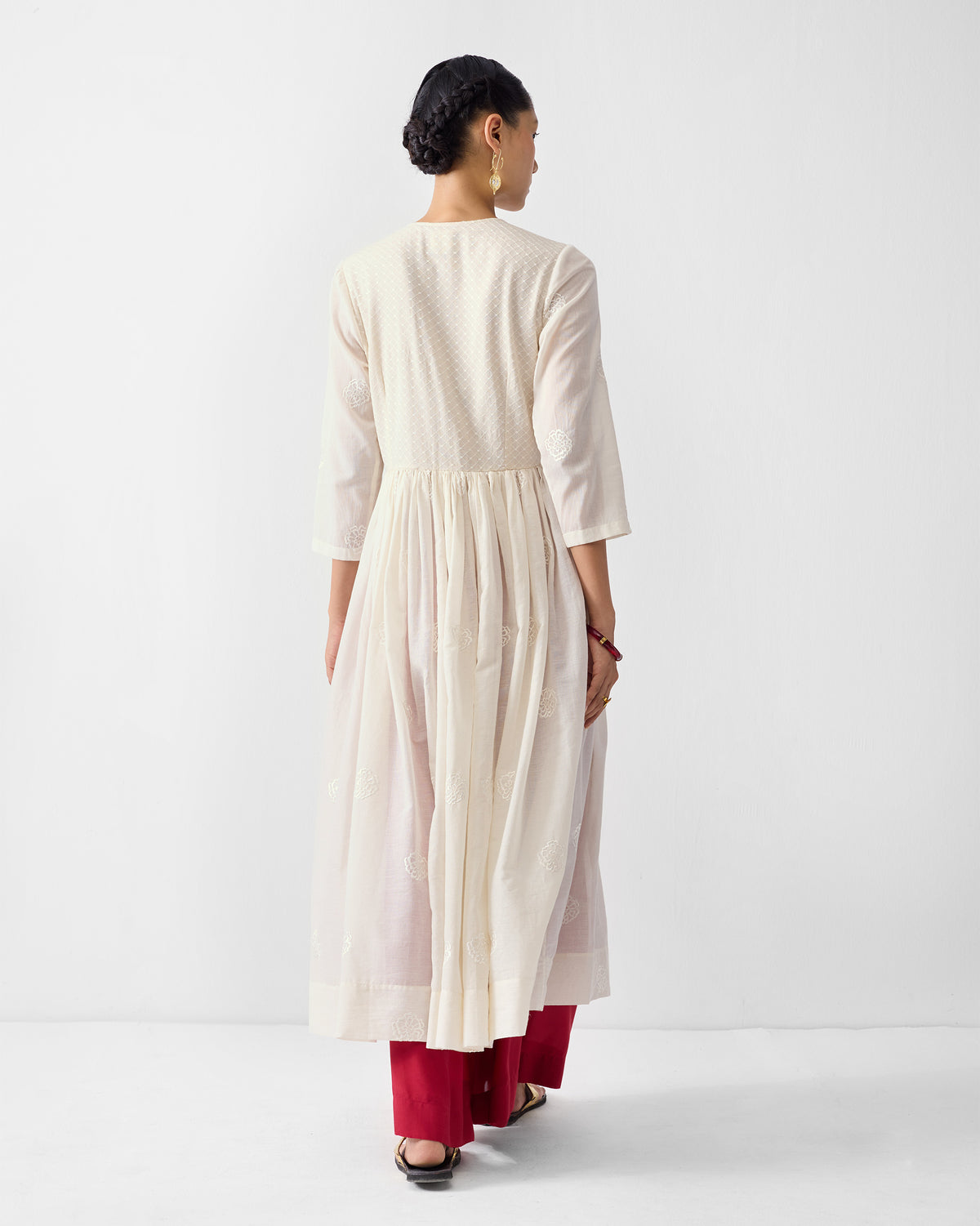 Back of an ivory Fit & Flare Angrakha with a gathered skirt.