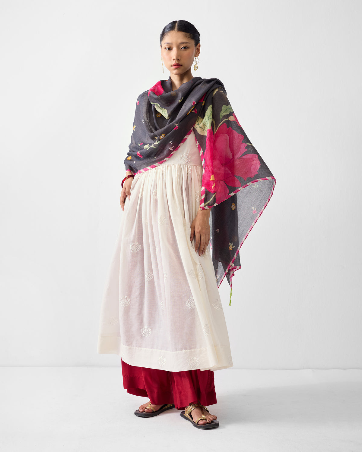 Person wearing an ivory embroidered Fit & Flare Angrakha with a floral dupatta.
