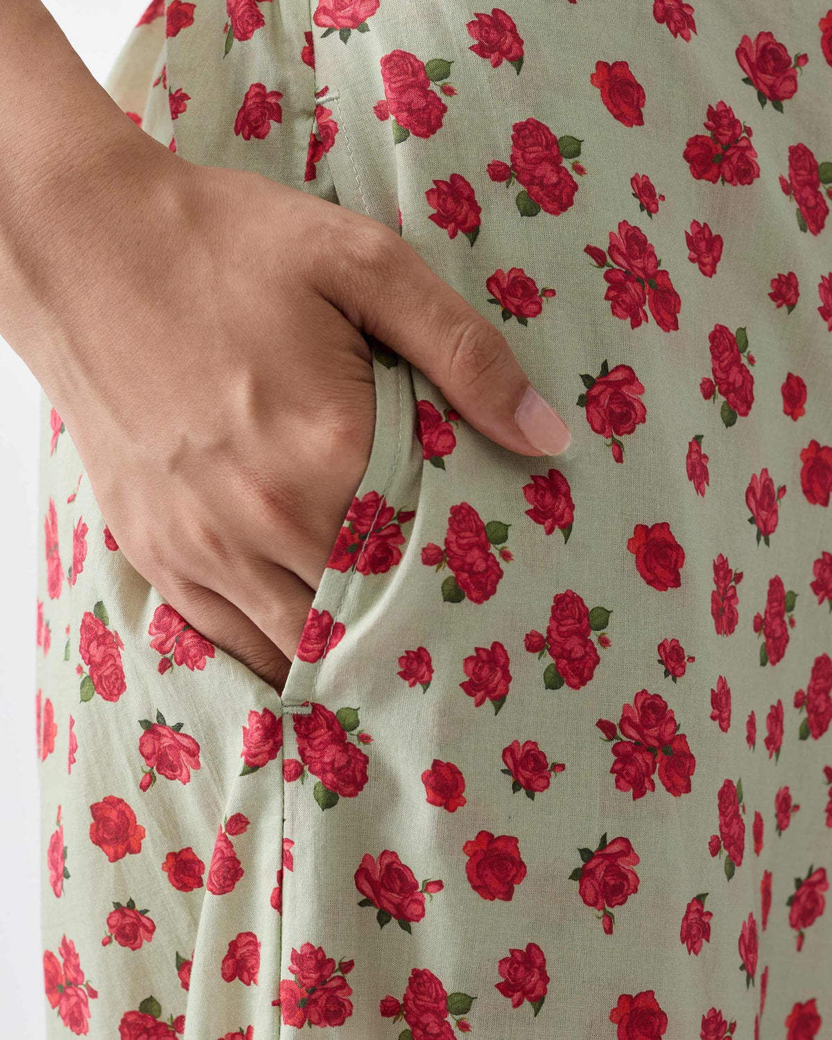 Close-up of mint and watermelon print Basic pyjamas showing the side pocket.