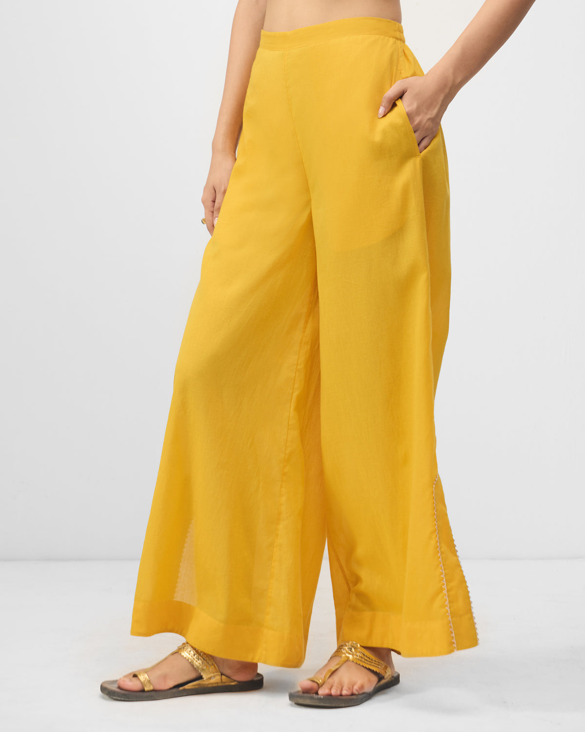 Turmeric yellow Ayat pyjamas worn at a three-quarter angle.