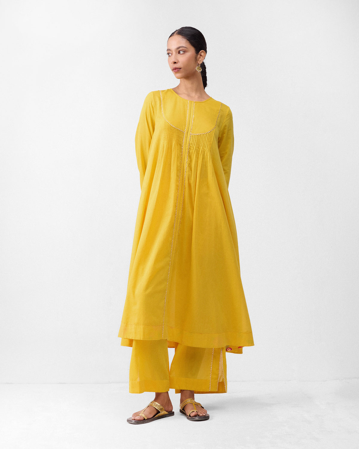 Person wearing turmeric yellow Ayat pyjamas with a matching long tunic.