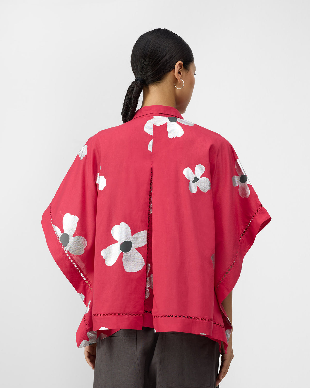 Back of a watermelon pink floral top with a center box pleat.
