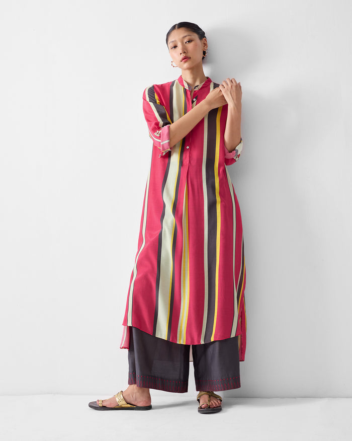 Person wearing a multicolor striped smocked back kurta.