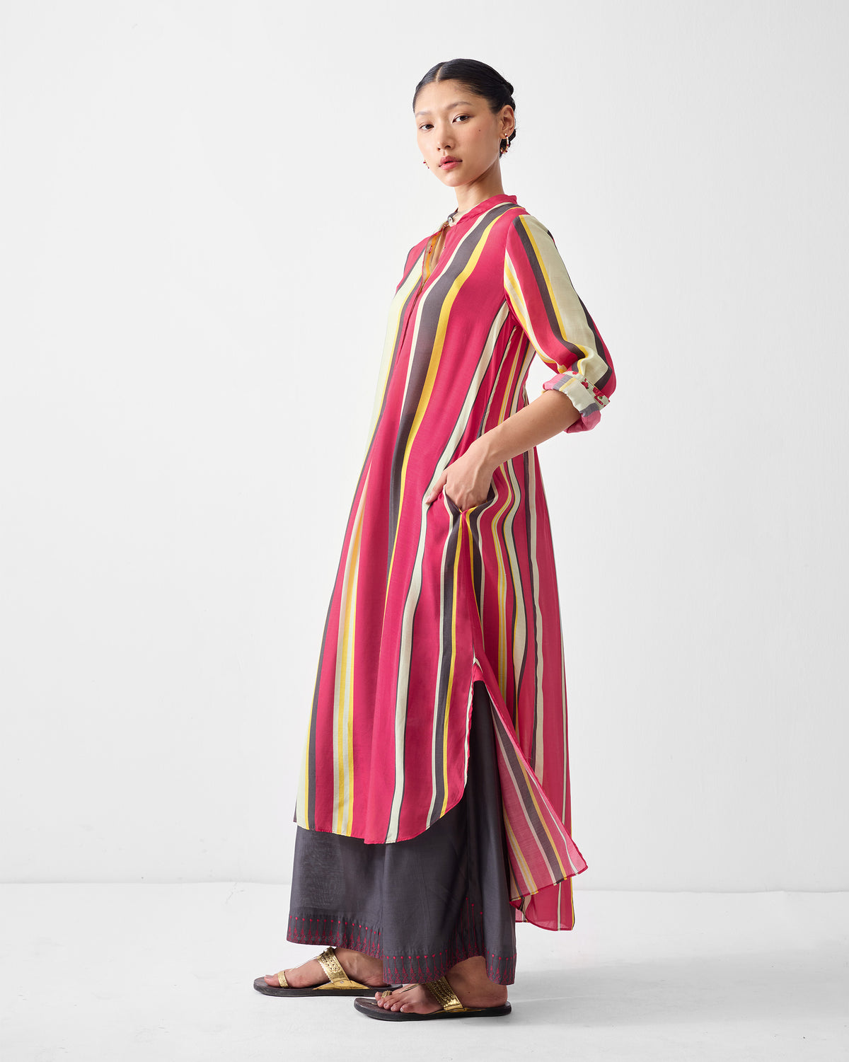 Three-quarter view of a multicolor striped smocked back kurta.