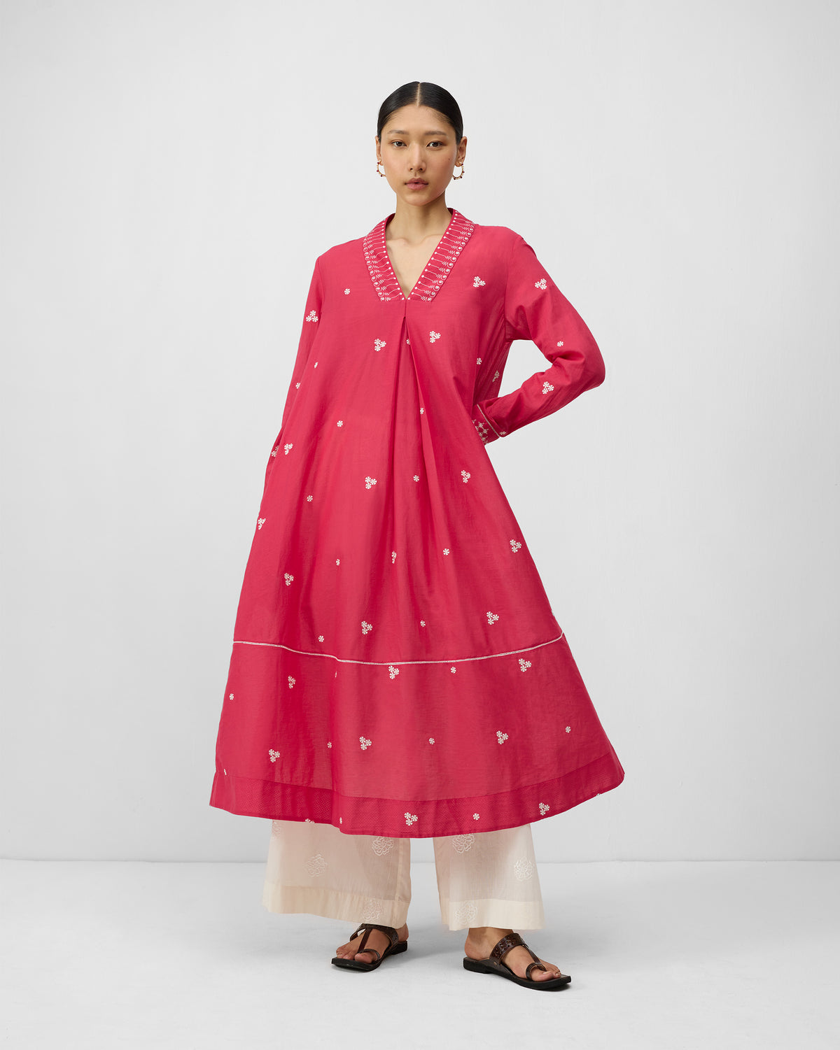 Person wearing a watermelon pink Banko kurta with ivory embroidered V-neck.