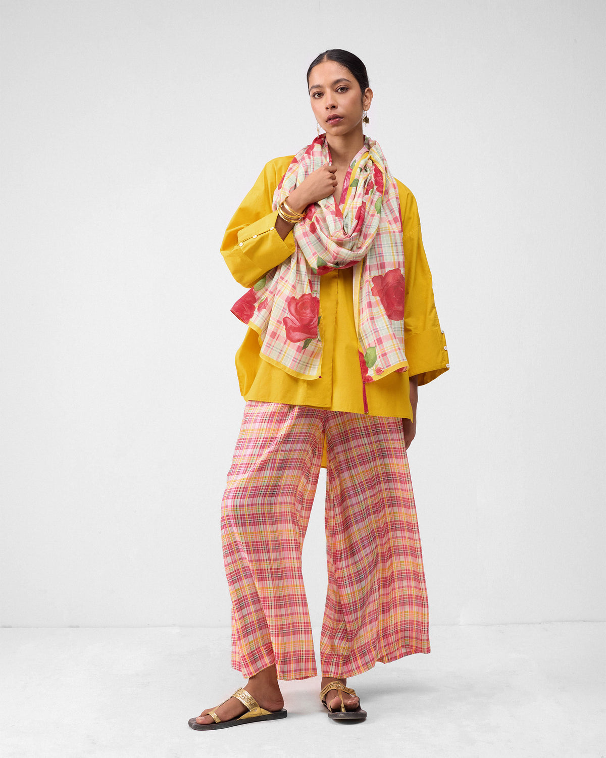 Person wearing multicolor check Classic Pyjama pants with a yellow shirt.