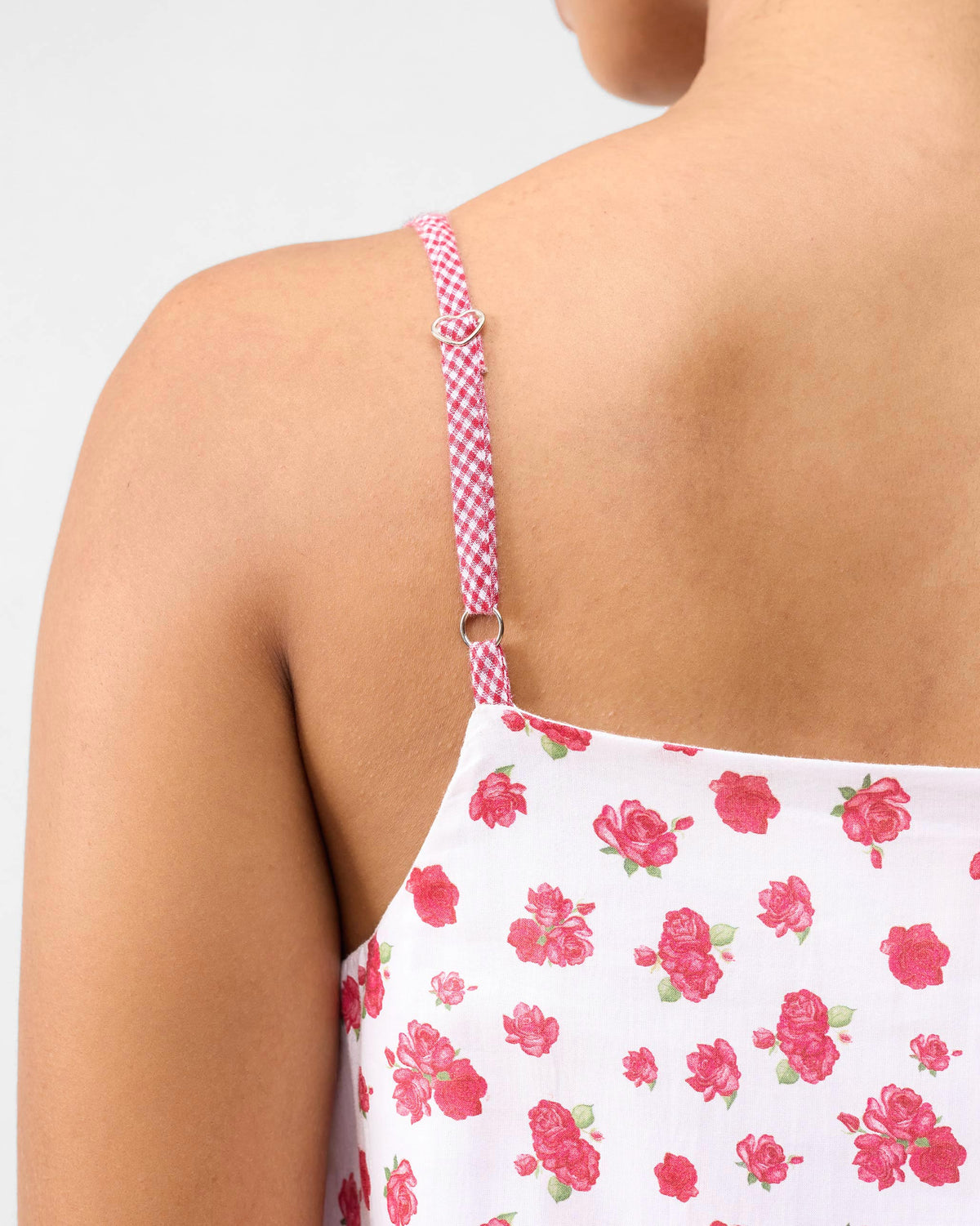 Close-up of a Kimsuka Dress showing a checked strap with a heart slider.