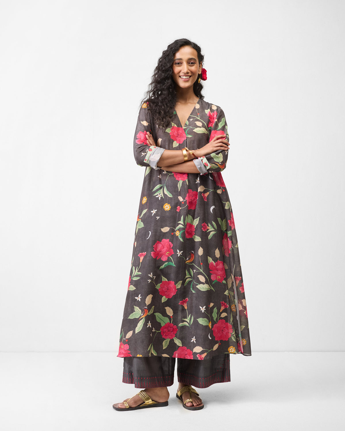 Person wearing a charcoal kurta with red floral print.