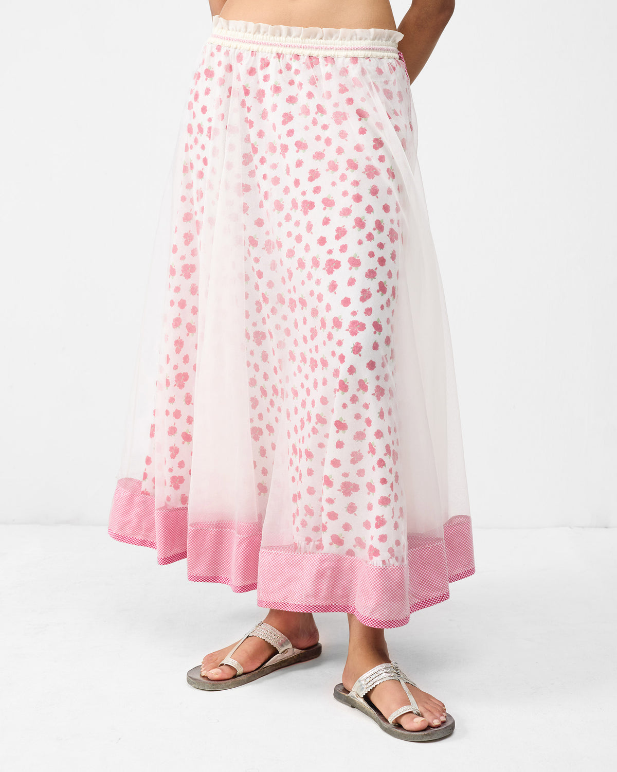 Ivory Pushkar skirt with watermelon florals under a sheer overlay and pink hem.