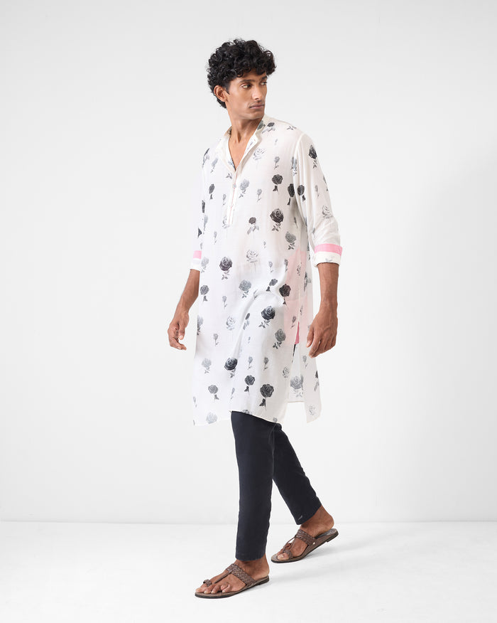 Person wearing a light grey Astral kurta with a rose print.