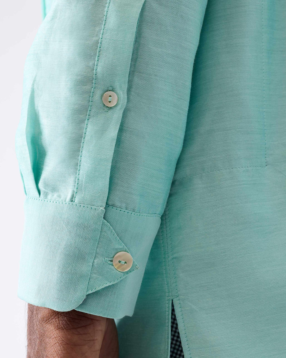 Close-up of the sleeve cuff on an aqua Naaz kurta.