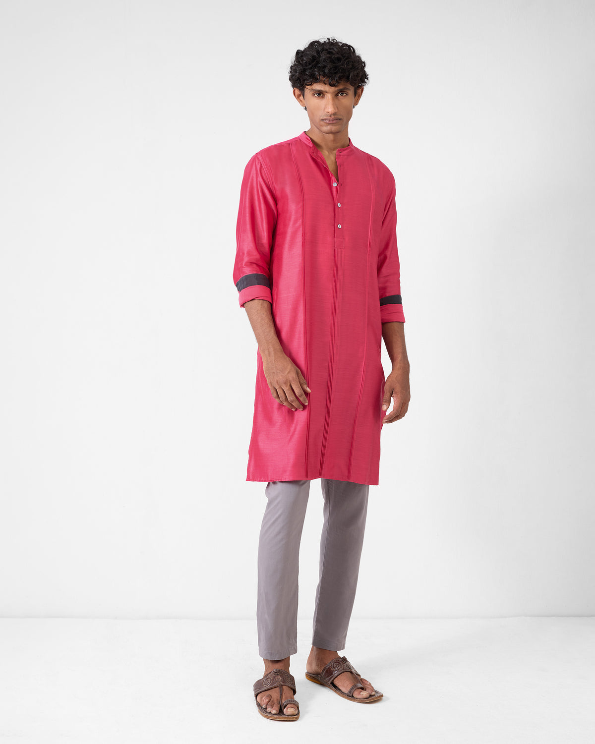 Person wearing a watermelon Naaz kurta with dark sleeve bands.