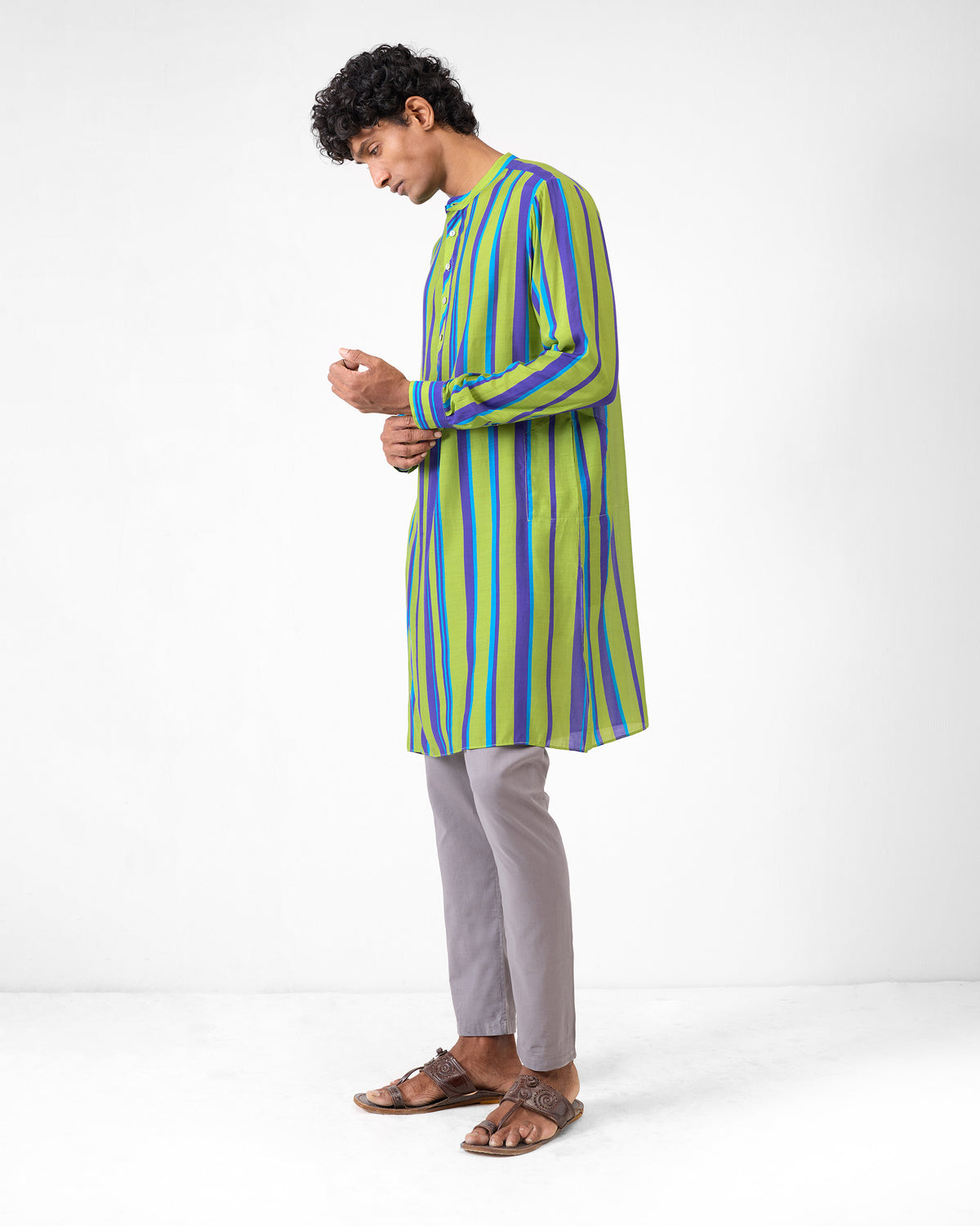 Side profile of a green and blue striped Jashn kurta worn by a person.