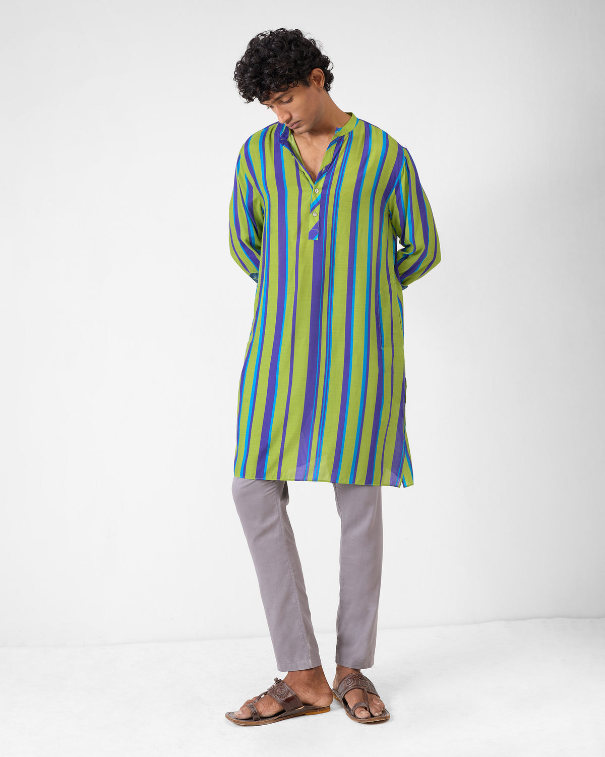 Person wearing a green and blue striped Jashn kurta to mid-thigh.