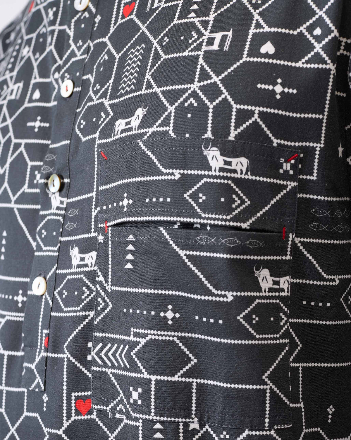 Close-up of a Galle Kurta showing a geometric animal print and red bartacks.