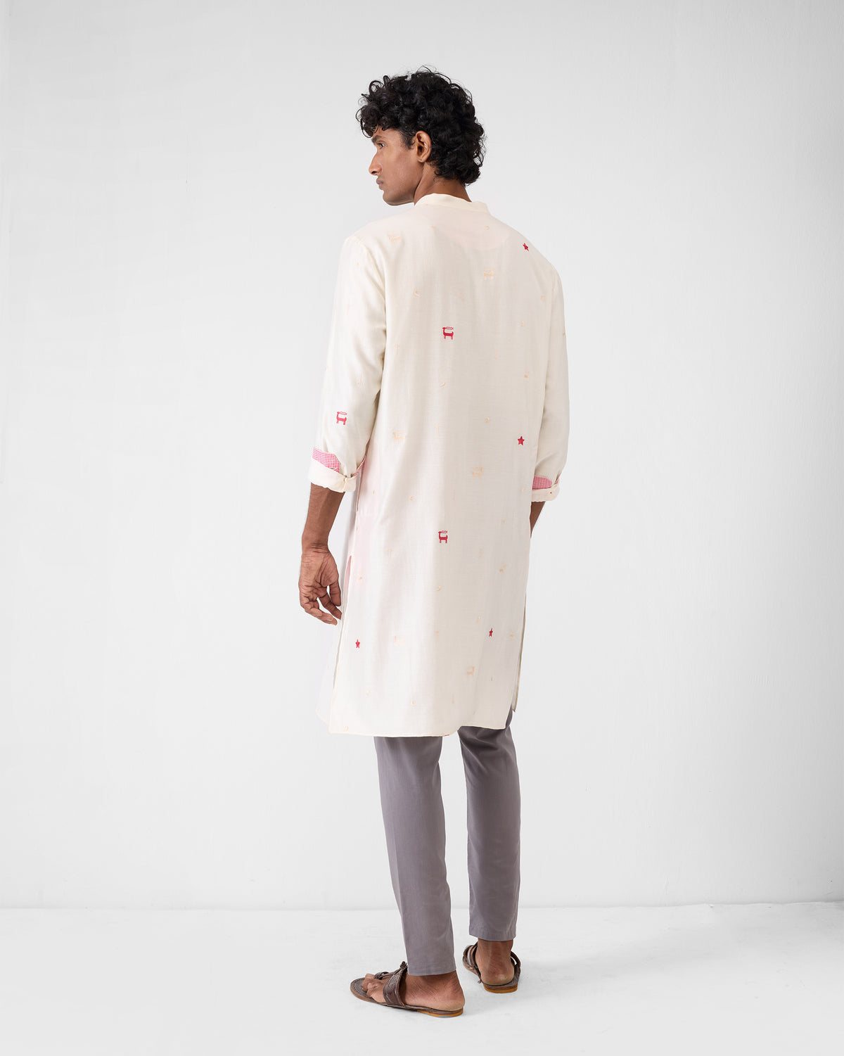 Back of an ivory embroidered neckband kurta with red motifs.