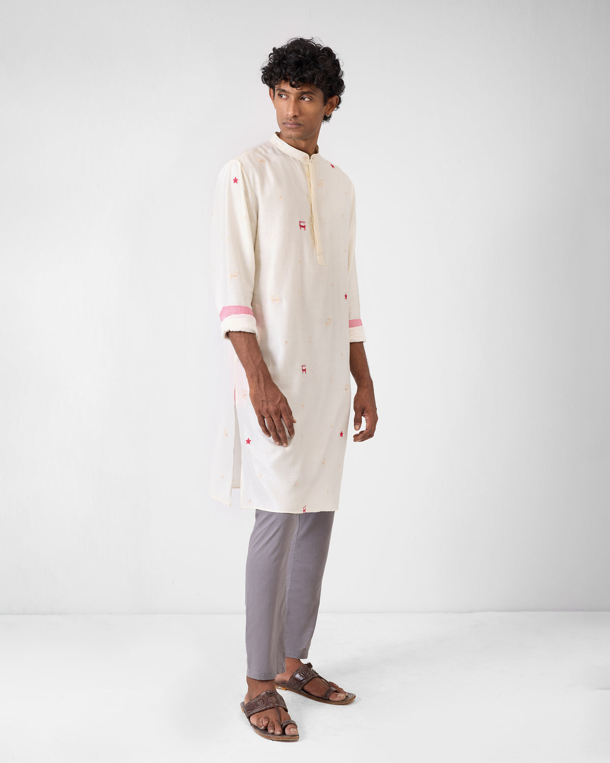Side view of an ivory embroidered neckband kurta worn by a person.