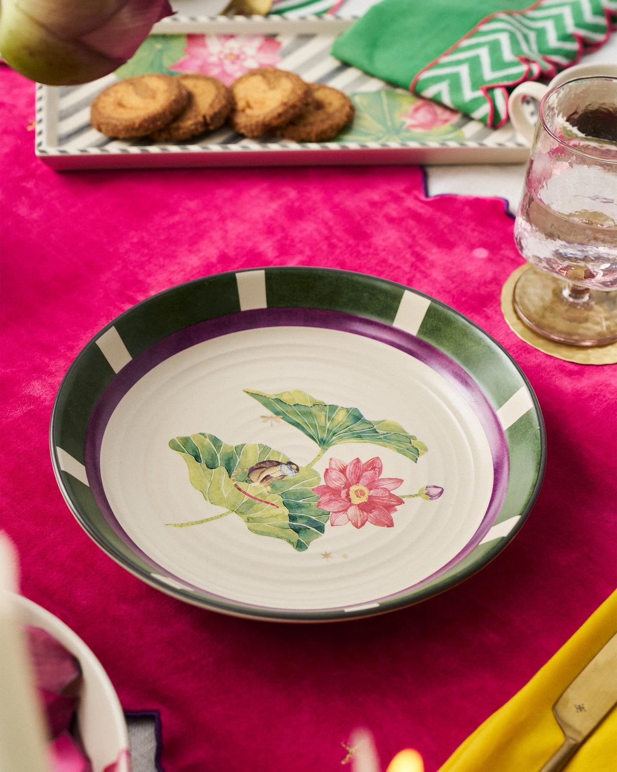 Lotus Garden pasta plate with lotus motif set on a pink tablecloth.