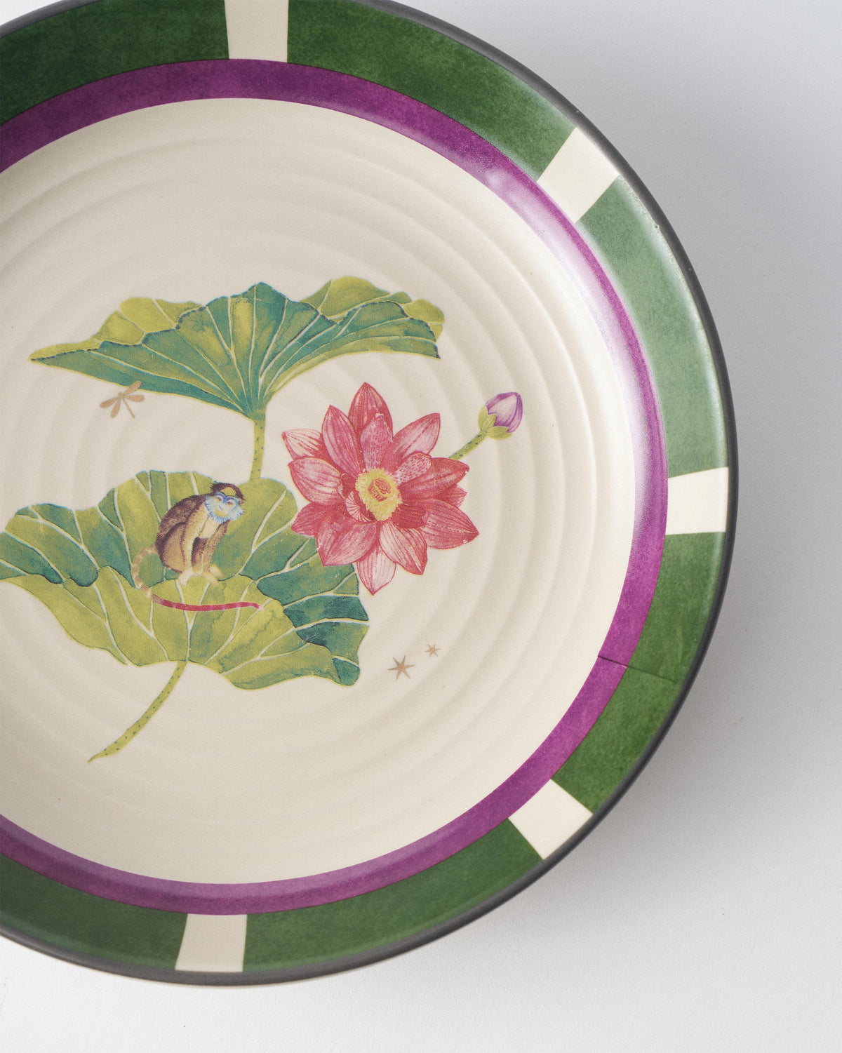Close-up of Lotus Garden pasta plate showing lotus and monkey motif.
