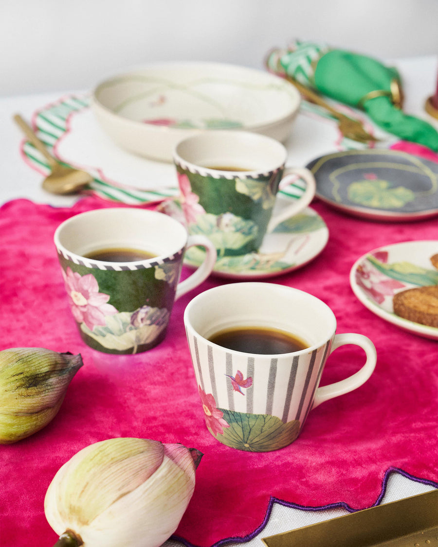 Float espresso mugs with coffee on a bright pink tablecloth