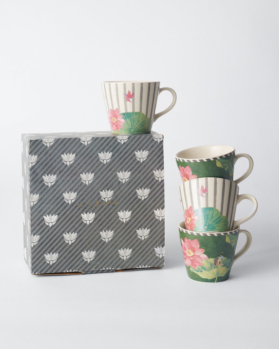 Float mugs stacked on and beside a grey patterned gift box