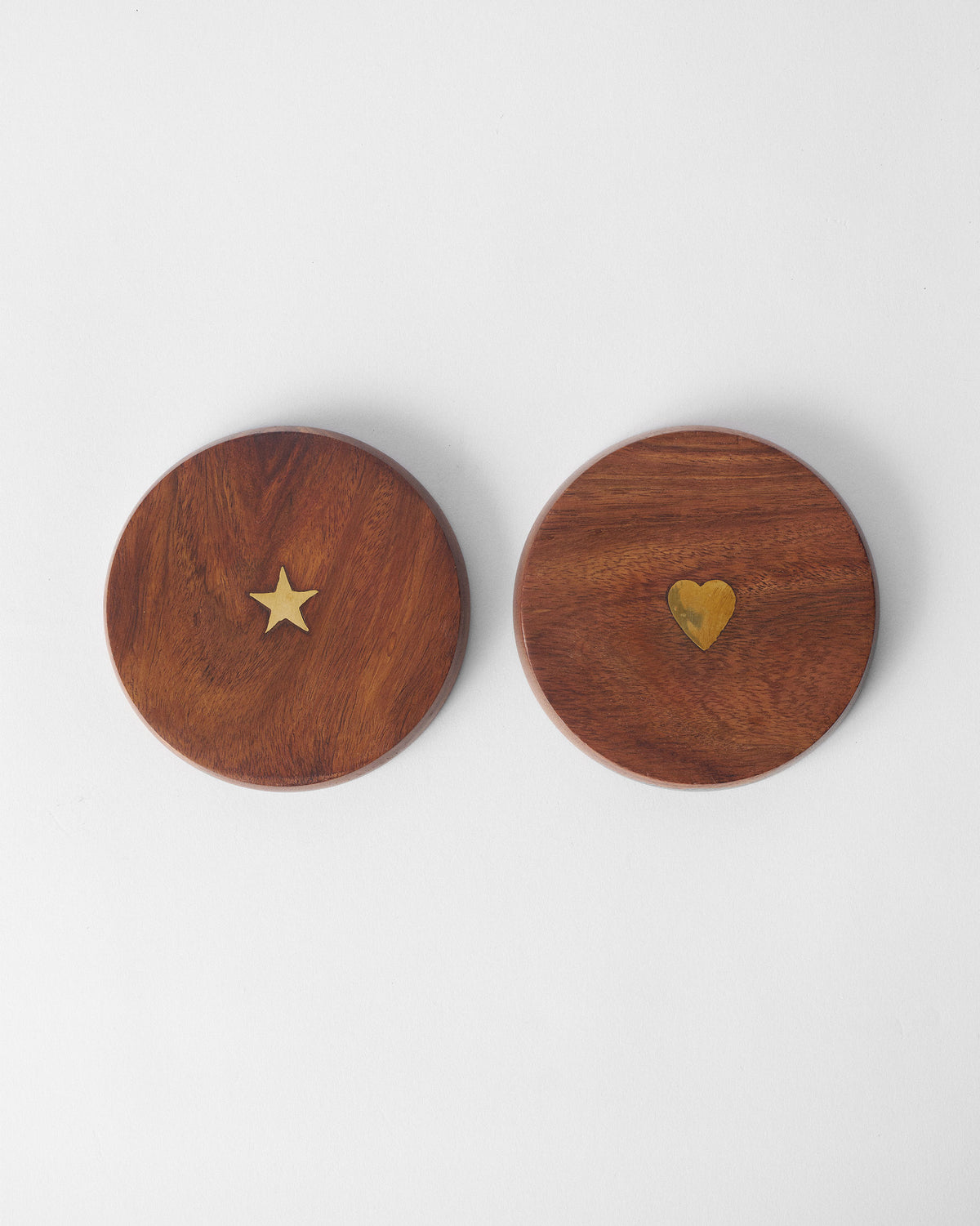 Pair of wooden Aster mug lids with brass star and heart inlays.