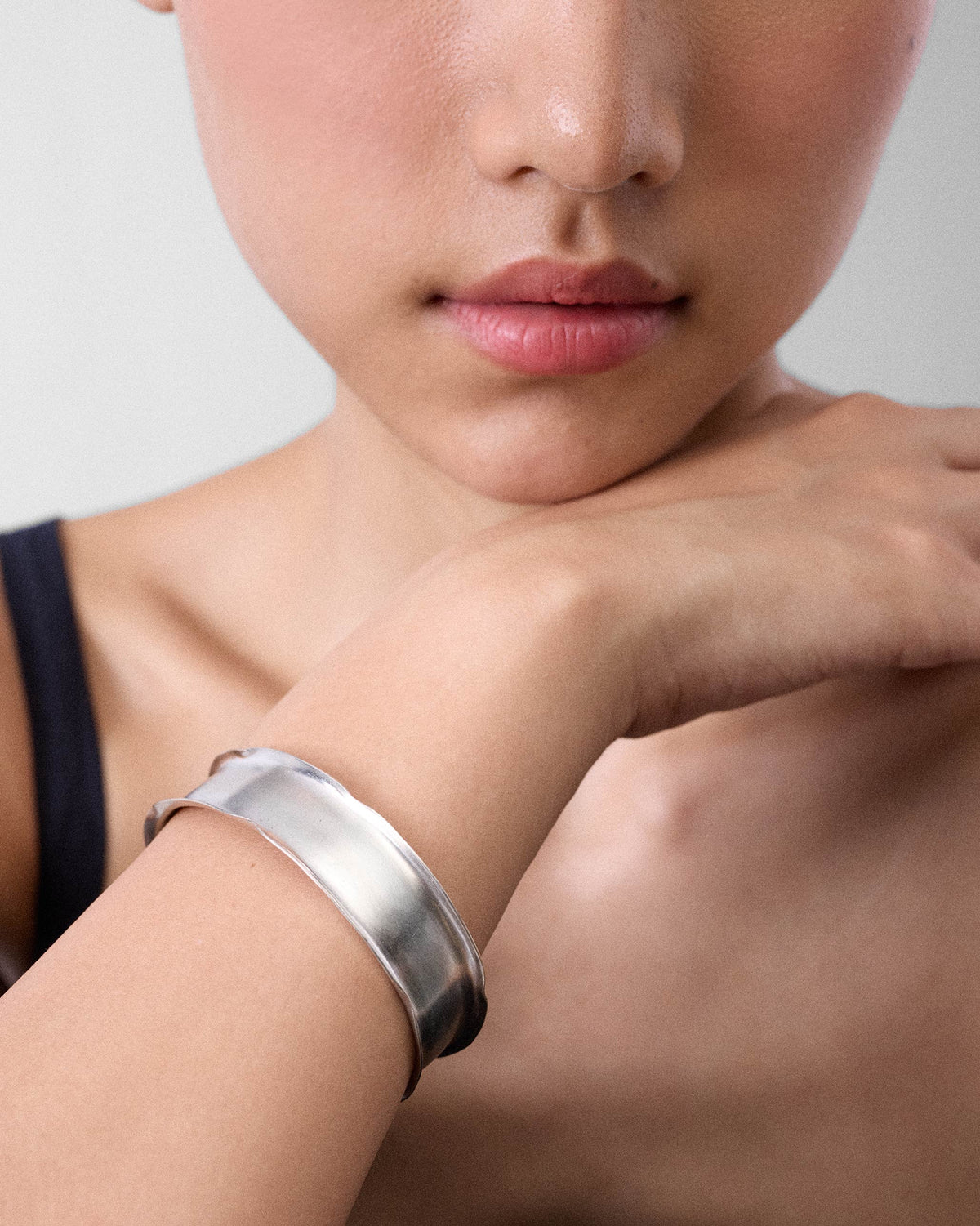 Thick silver Batur bangle worn as a wide cuff on a wrist.