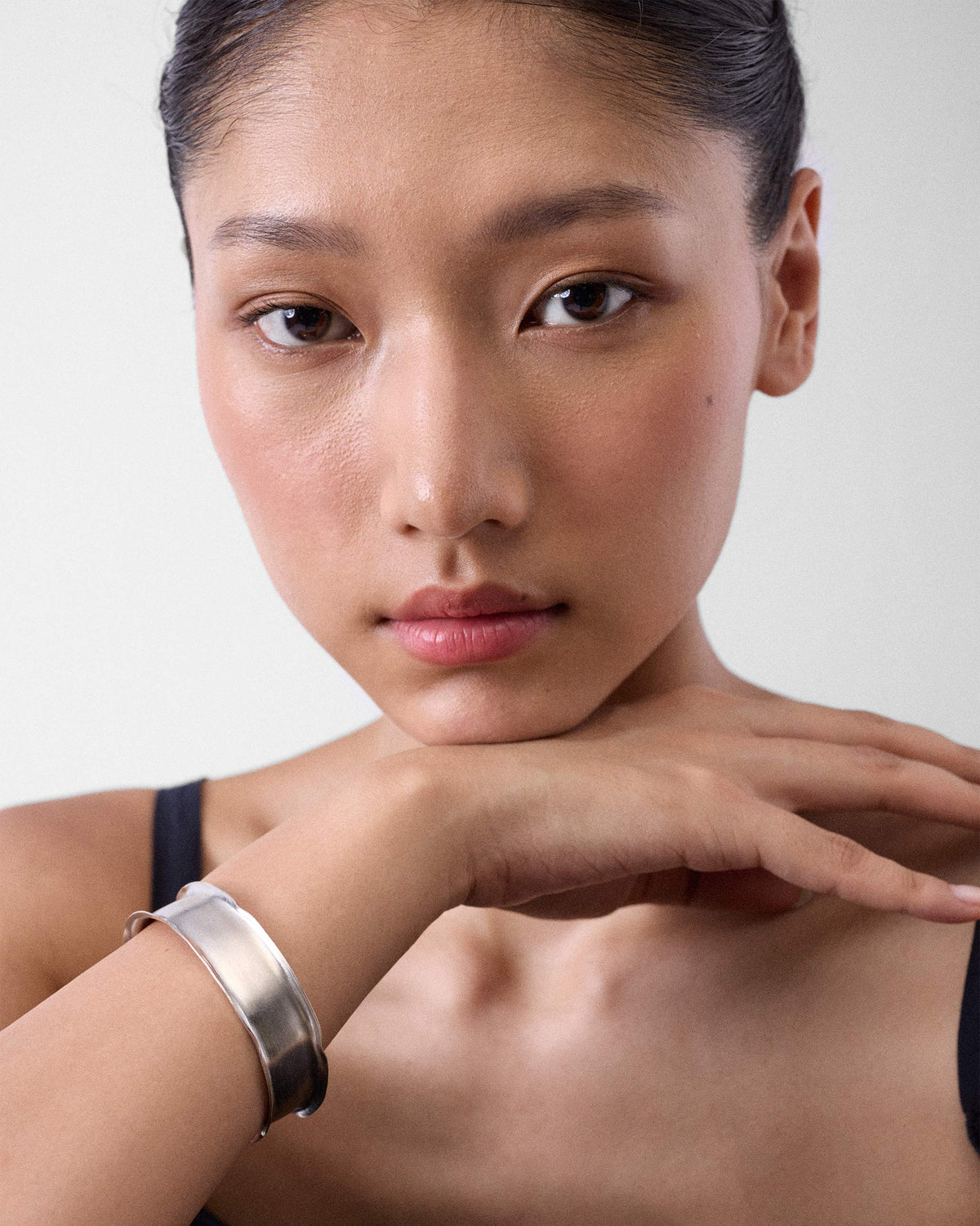 Person wearing a thick silver Batur cuff bangle on the wrist.