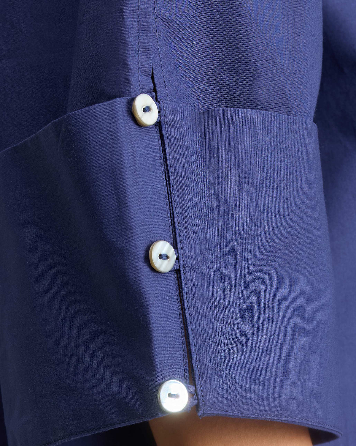 Close-up of an ink blue Cirrus Shirt cuff with three buttons.