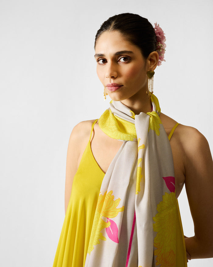 Person wearing a grey Floral Scarf with large yellow blooms and pink edging.