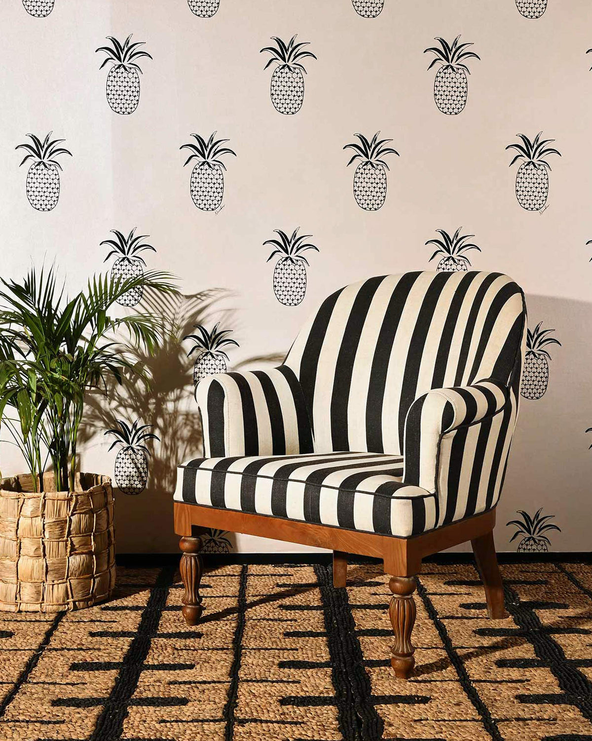 Cove Arm Chair in black and cream stripes, shown in a styled room.