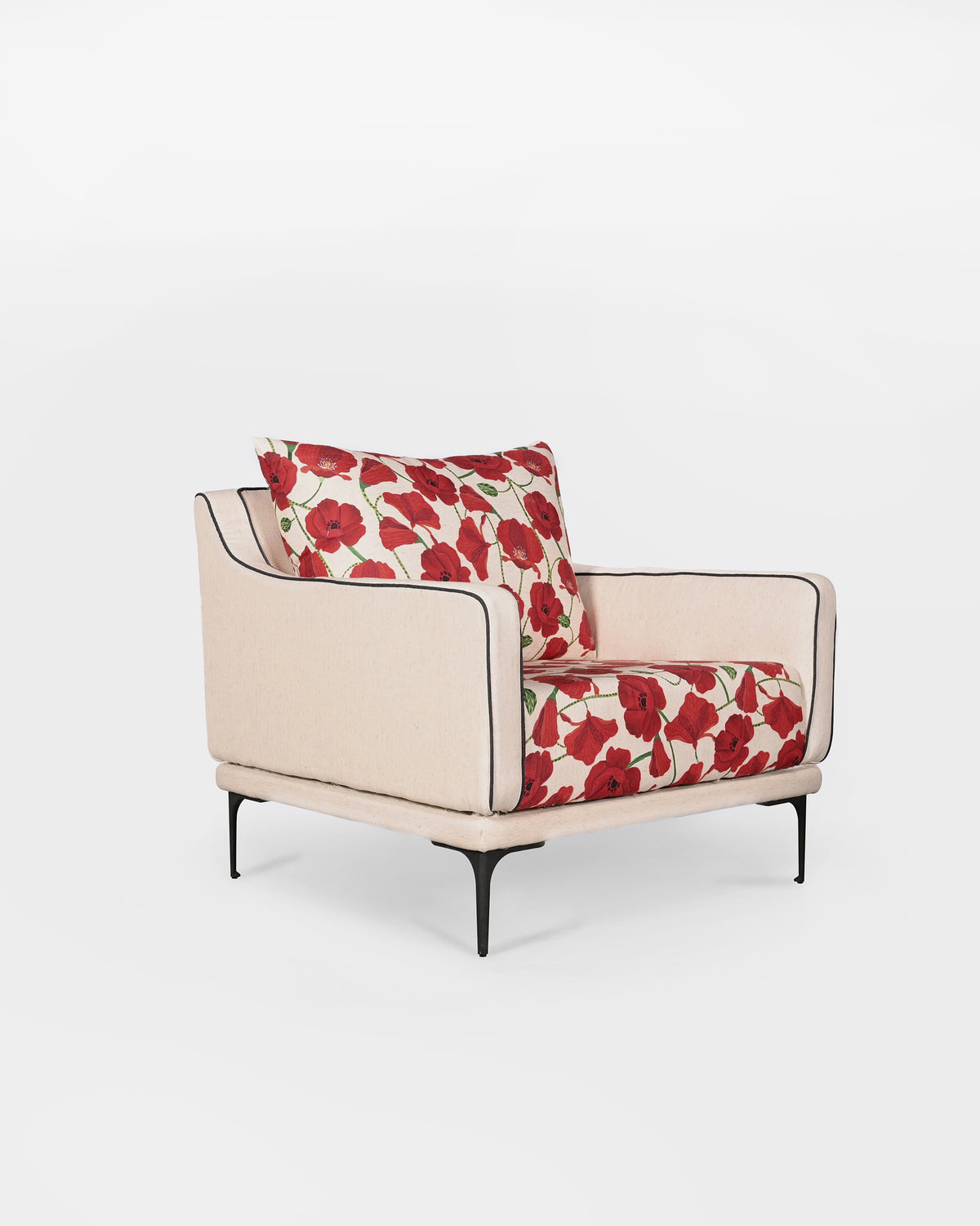 Three-quarter view of a Field lounge chair with red poppy cushions.