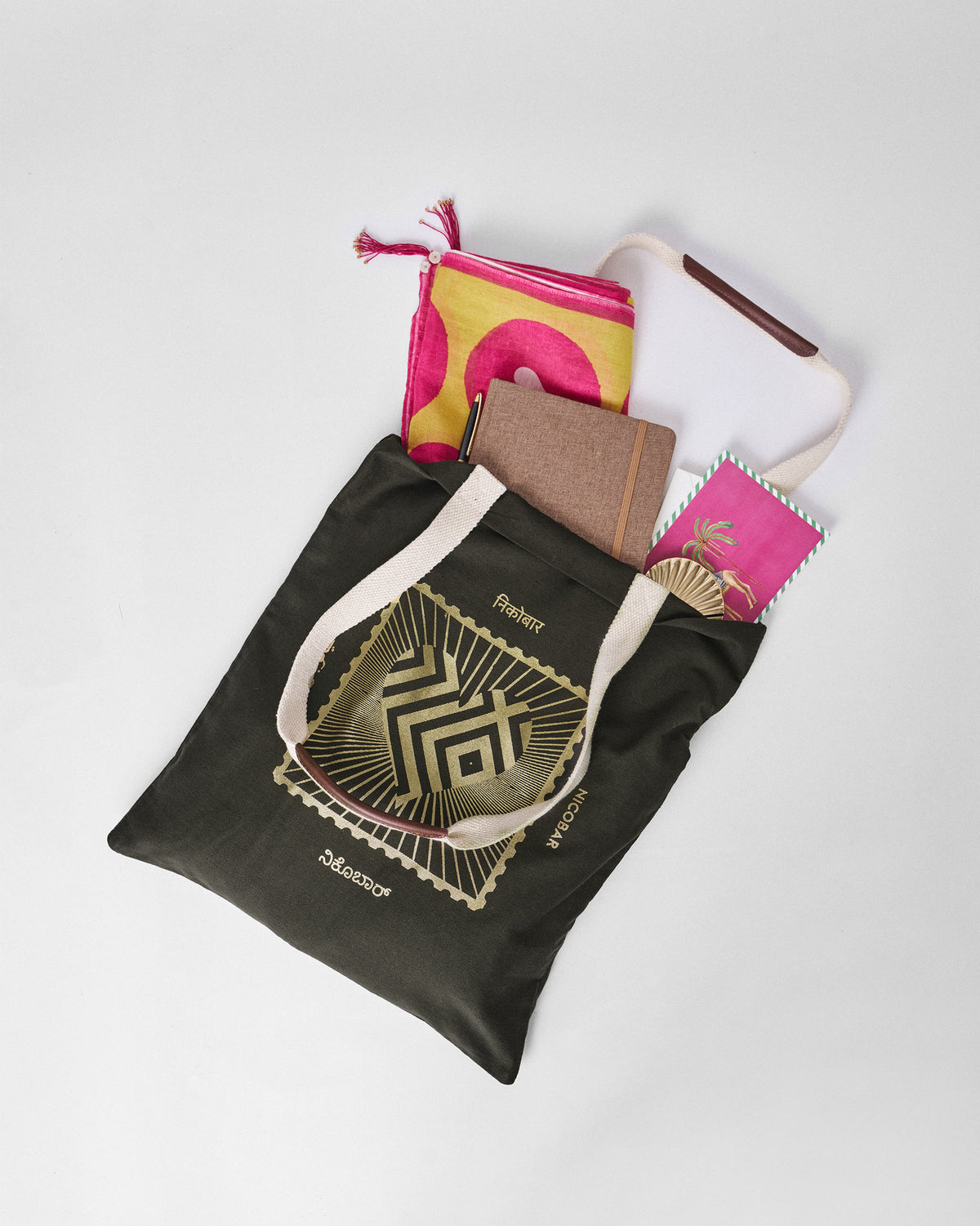 Charcoal Road To 10 Tote packed with a notebook and scarf, gold stamp graphic visible.