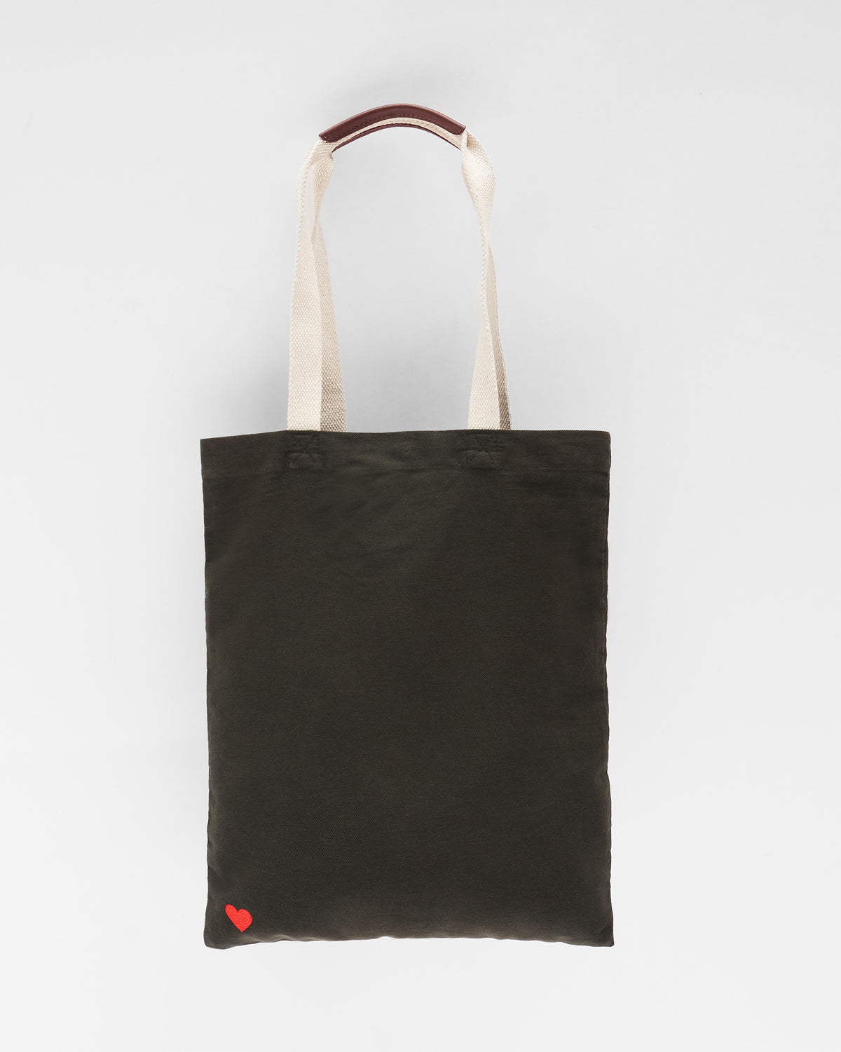 Charcoal Decade Tote with cream straps and a small red heart detail.