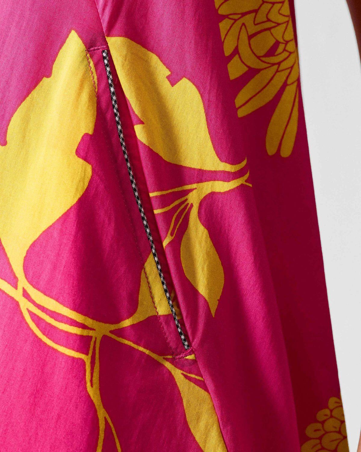 Close-up of a fuchsia lantern top pocket with yellow print and checkered trim.