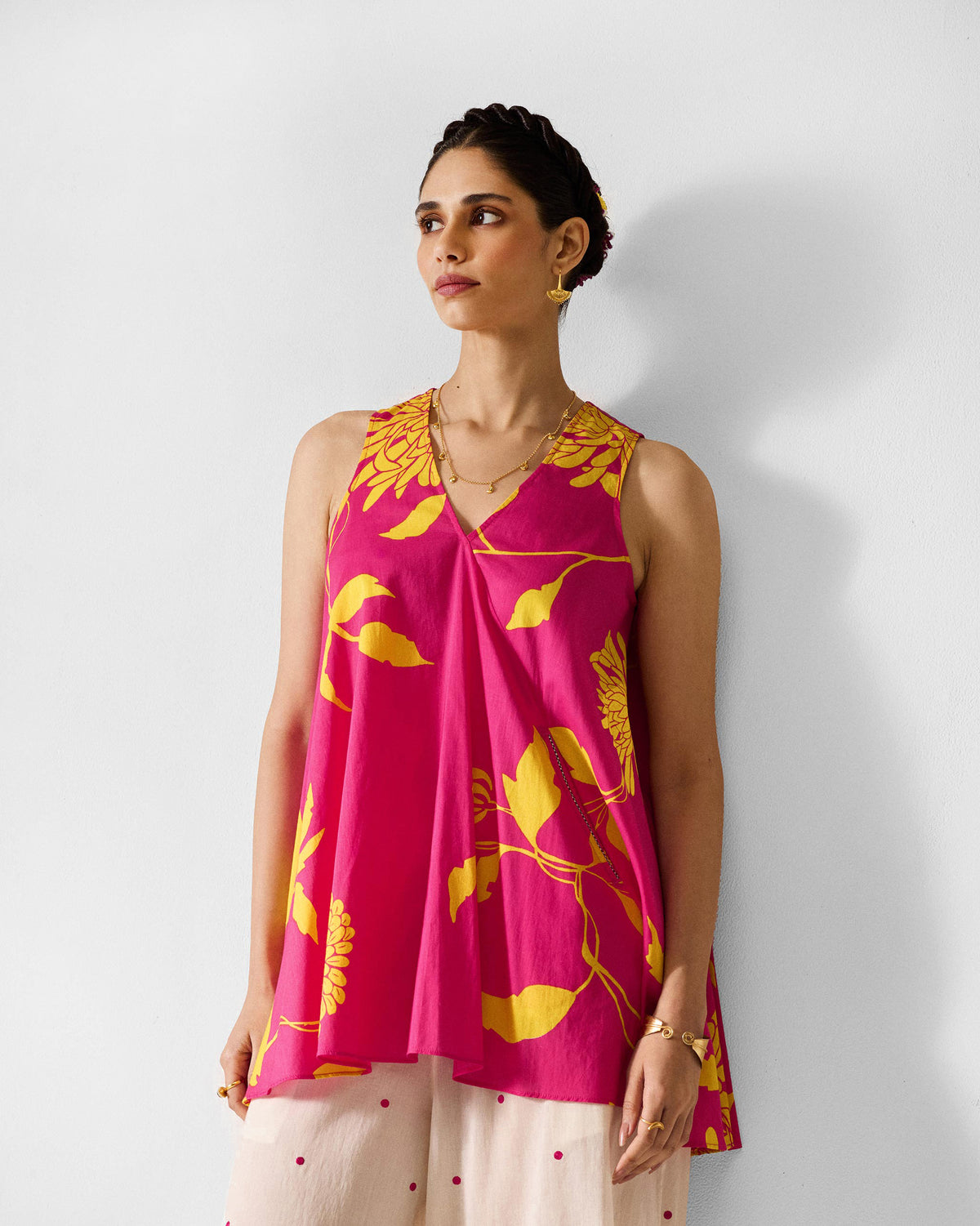 Fuchsia lantern top with a V-neck and yellow floral print worn by a person.