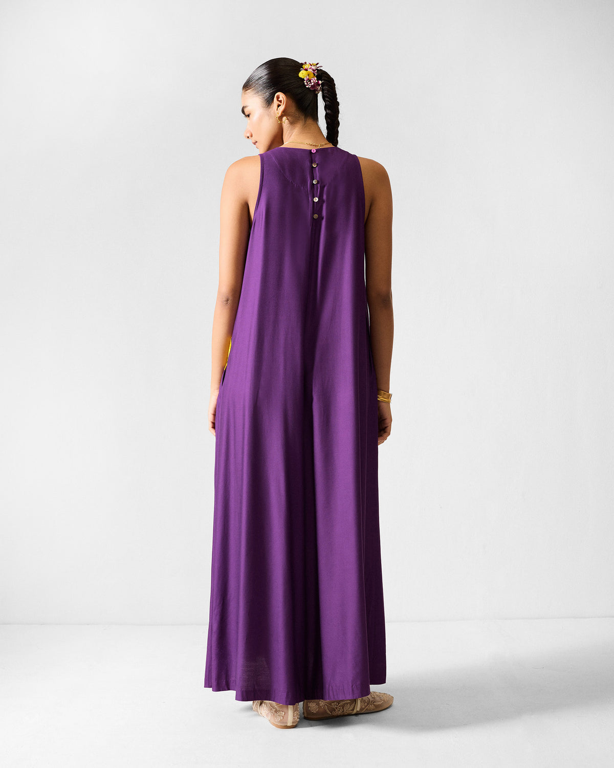 Back of a purple Amreli jumpsuit with a center button placket.