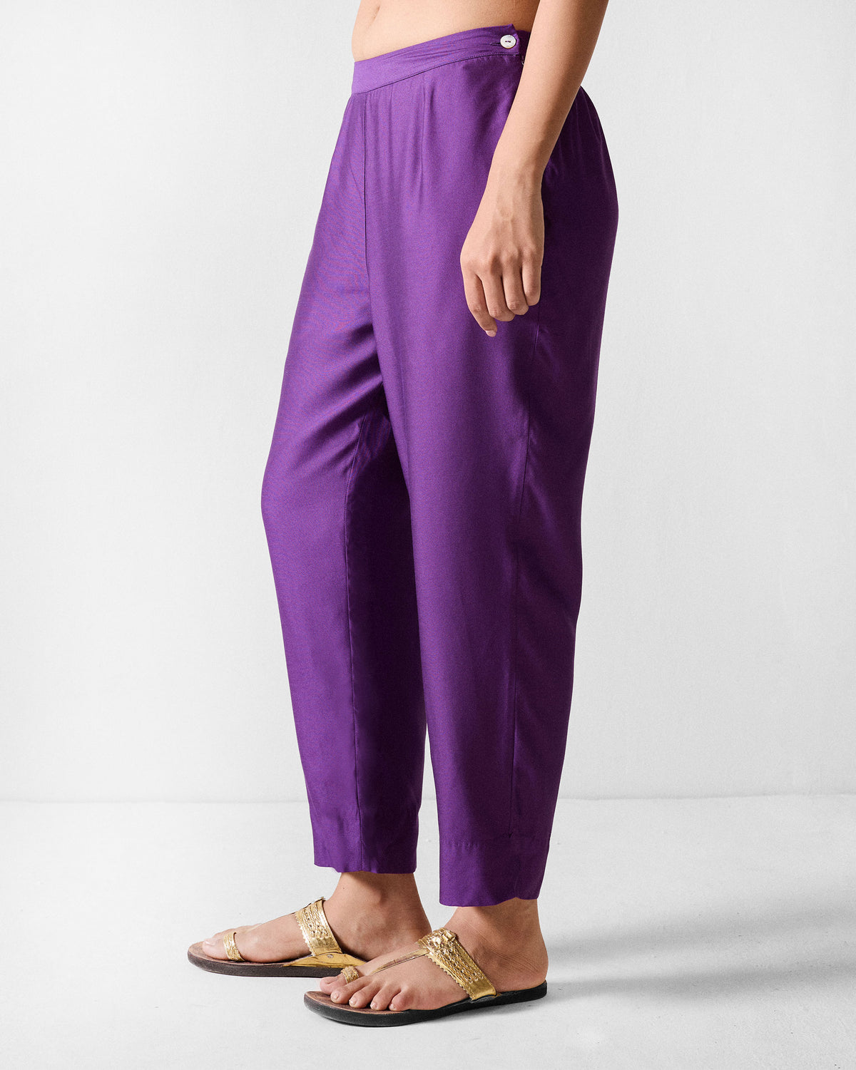 Side view of purple Darjeeling pants showing the tapered leg and side waistband button.