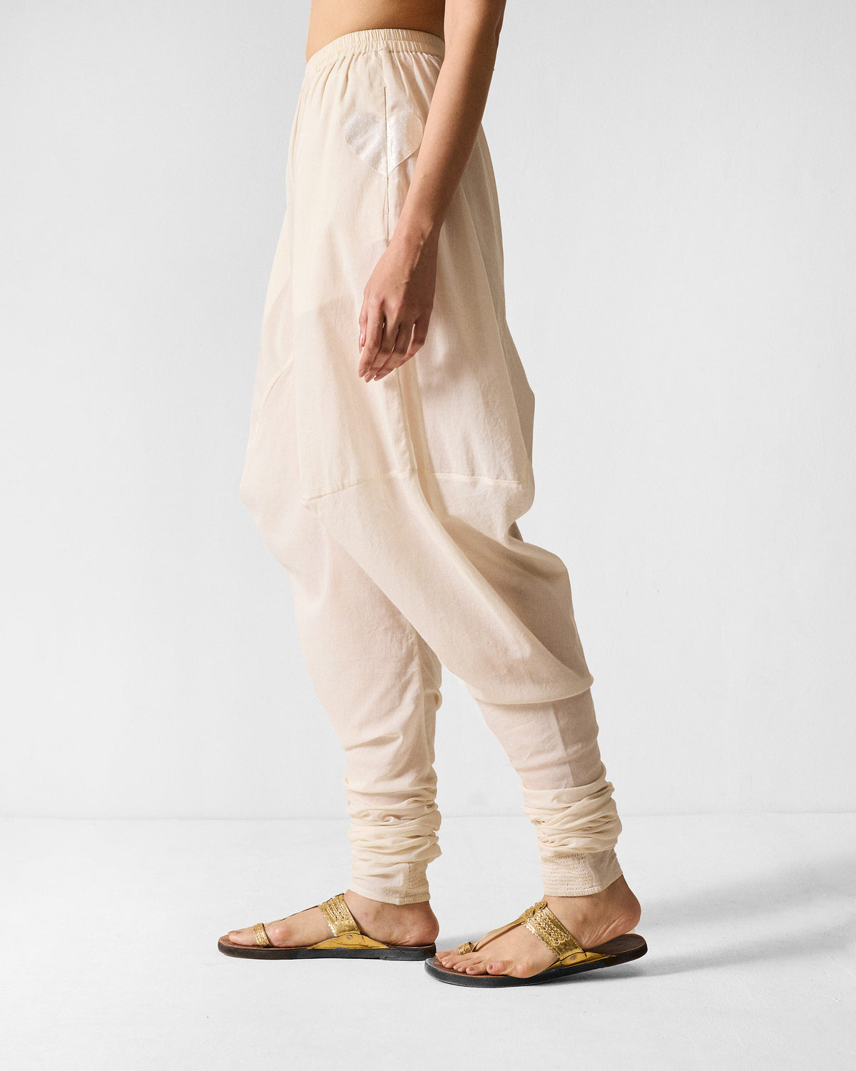 Side view of ivory Jaisalmer Pants with a small heart detail at the hip.
