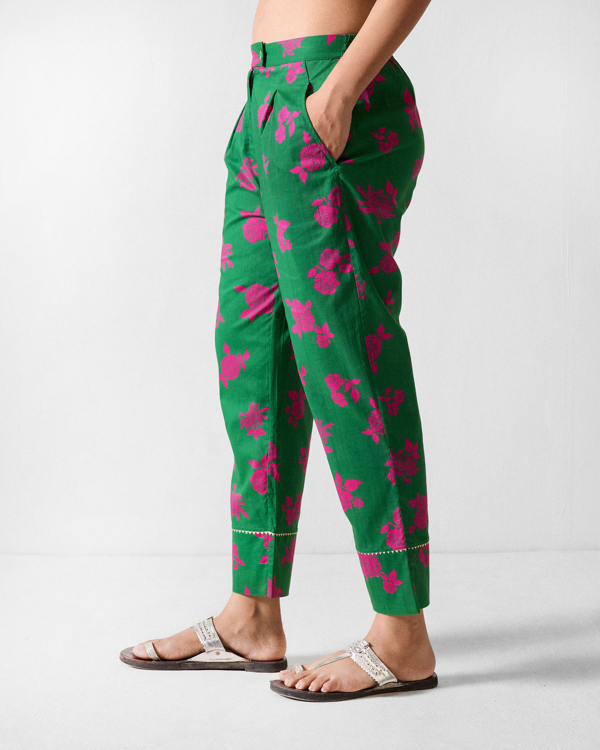 Side view of green printed Novel narrow pants showing the tapered crop and floral print.