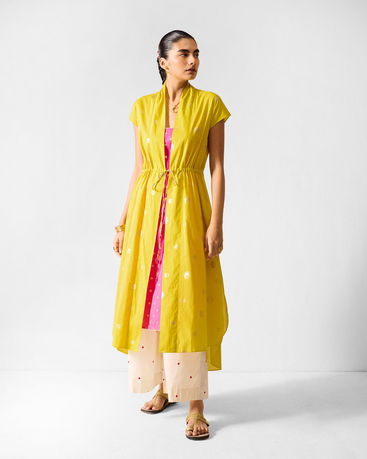 Chartreuse Myra overlay worn open with a gold drawstring at the waist.