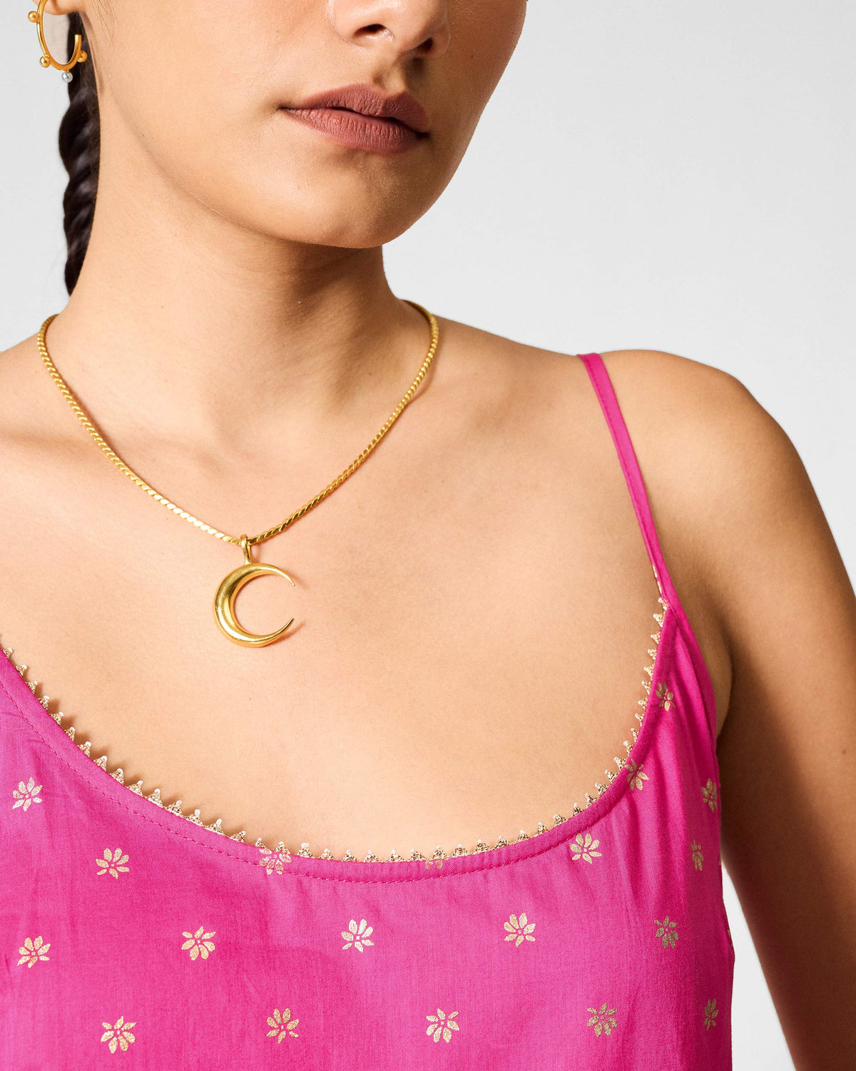 Close-up of a fuchsia Vintage Camisole neckline with gold edging.