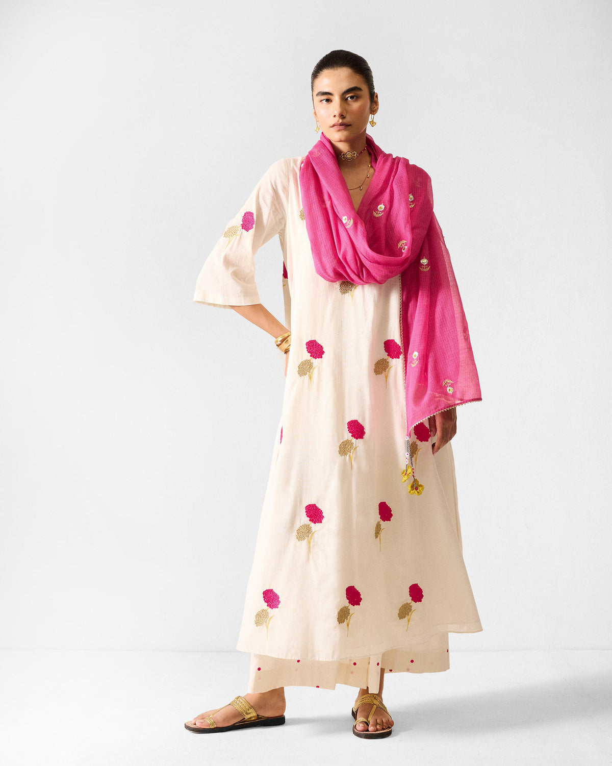 Person wearing an ivory embroidered Hampi Kurta with a fuchsia dupatta.