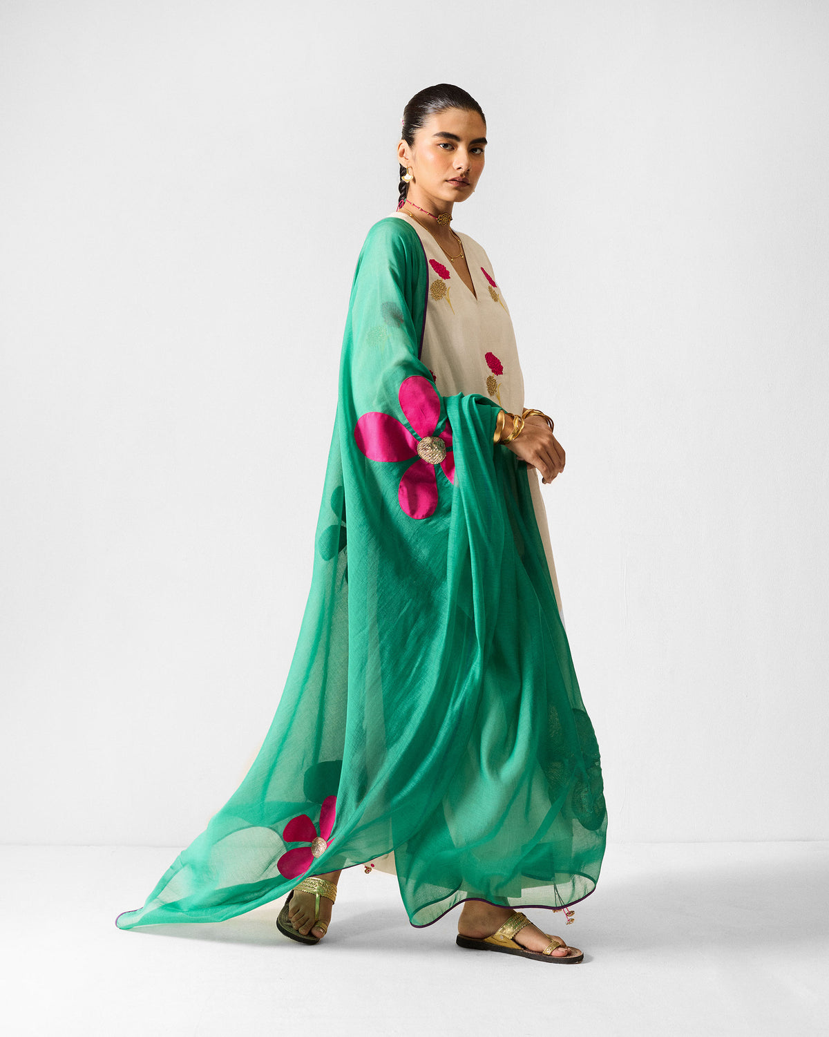 Person wearing an ivory Hampi Kurta with a green floral dupatta.