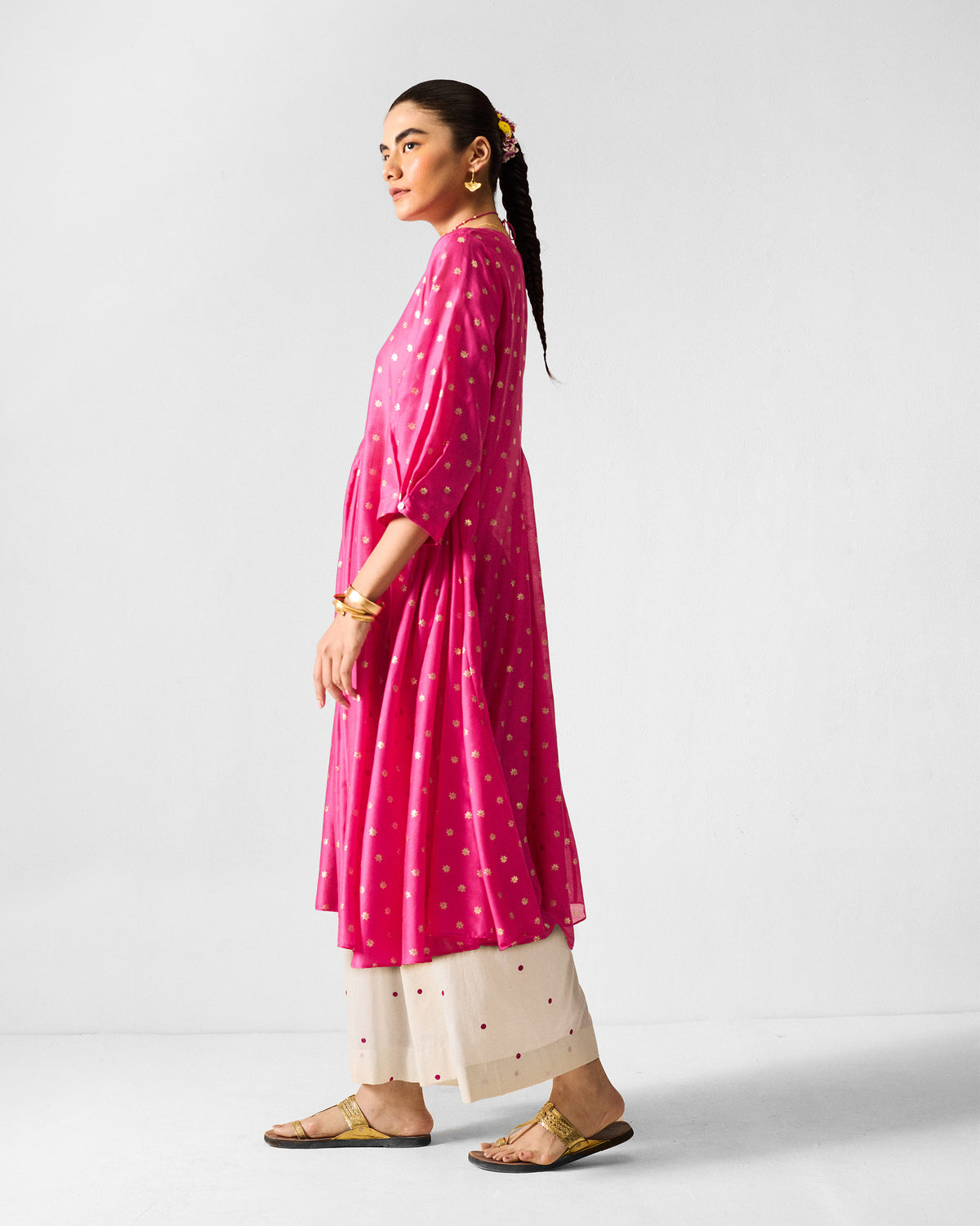 Side view of a fuchsia Kannauj Kurta with gold floral prints.