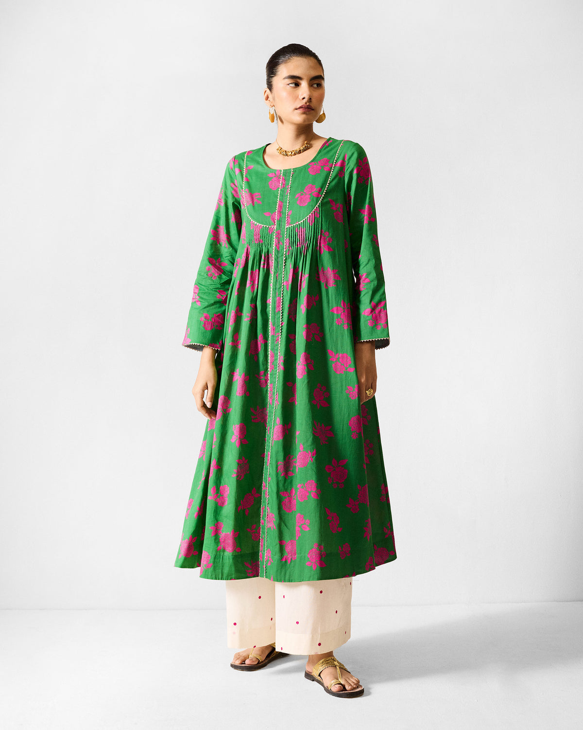 Person wearing a green and fuchsia printed Ayat kurta with cream yoke trim.