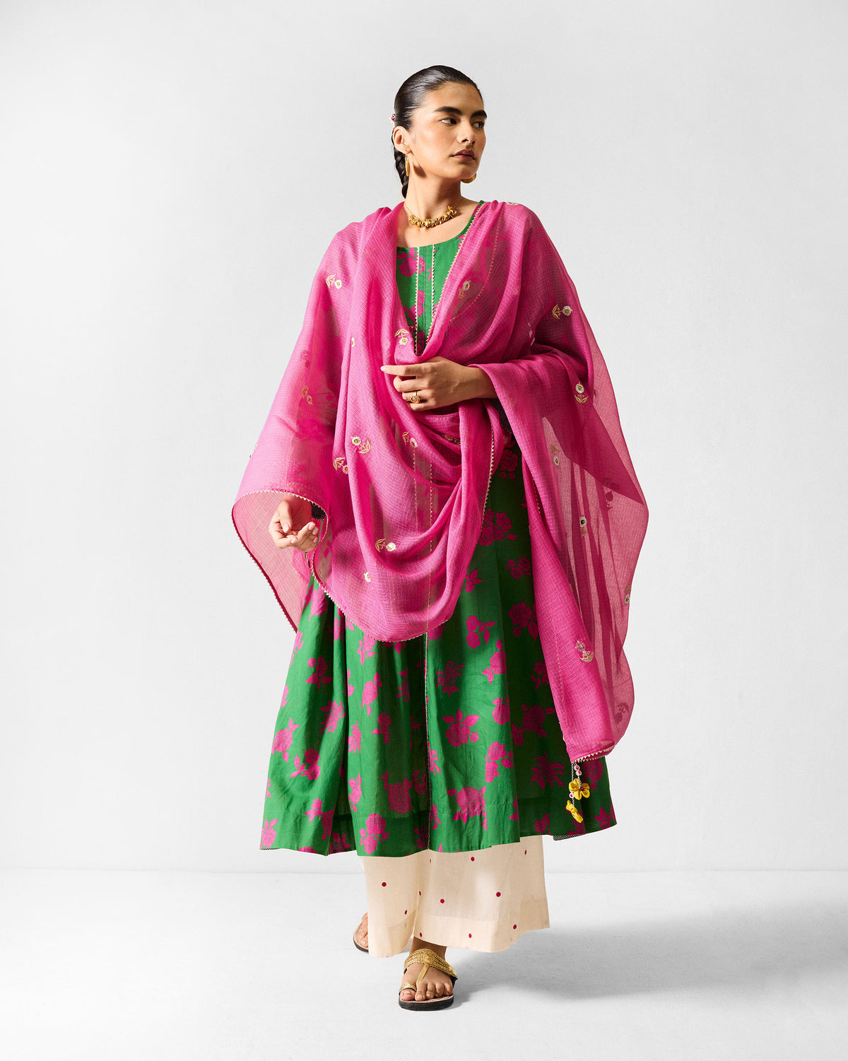 Person wearing a green and fuchsia Ayat kurta with a sheer fuchsia dupatta.
