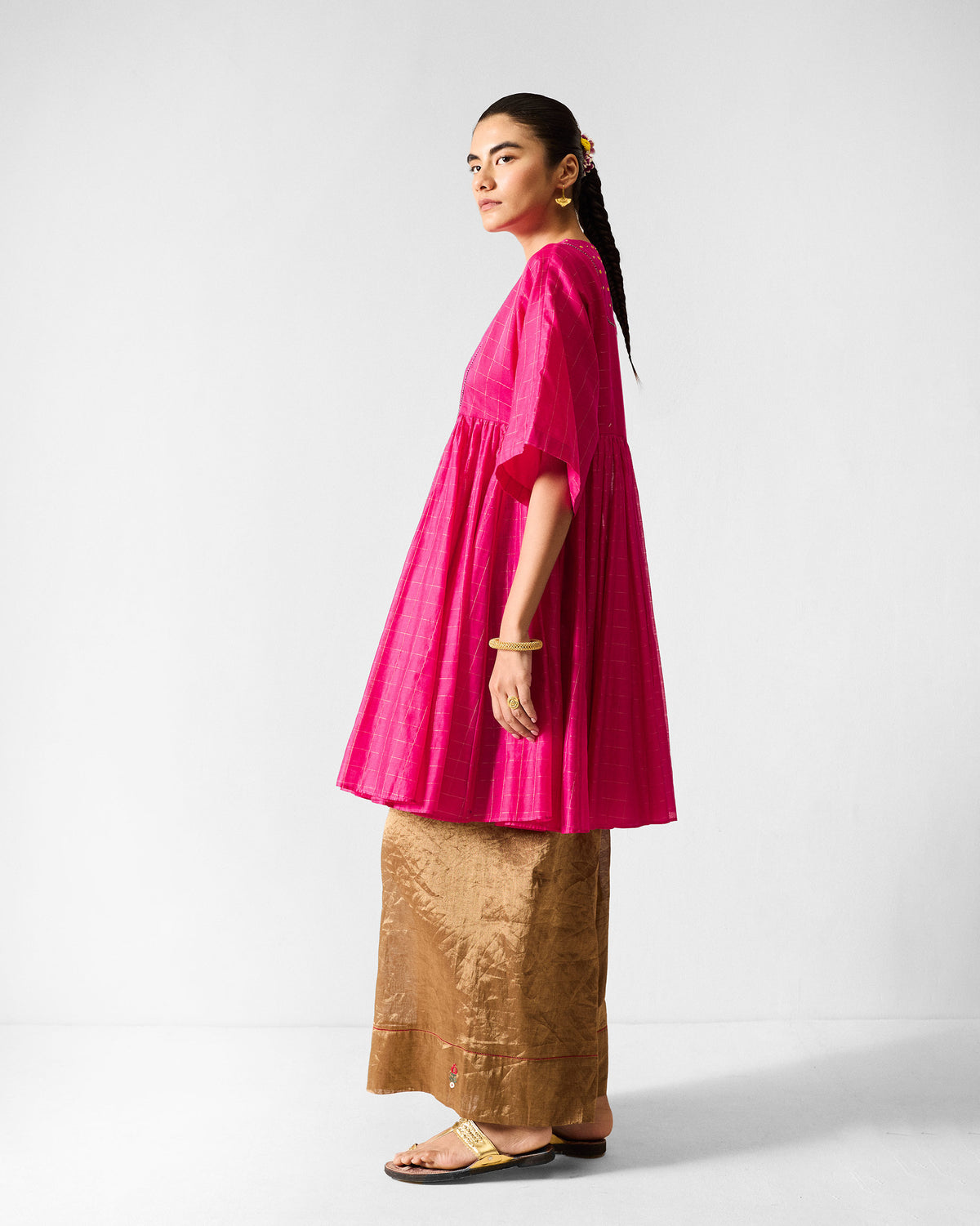 Side view of a fuchsia Luna Afghan Kurta showing the gathered flare.